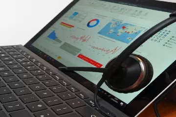 Laptop with headset resting on screen